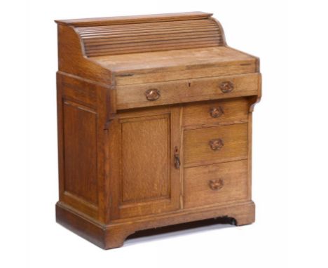 THE BRADFORD DESK.  AN OAK DESK BY CHRISTOPHER PRATT & SONS, BRADFORD, C1900  with tambour shutter, two red leather inlet fol