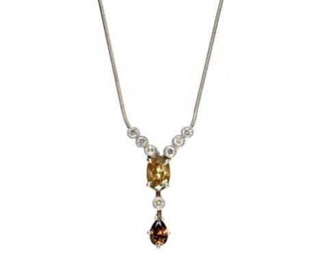 A DIAMOND NECKLET  the Y shaped pendant with diamond collets and larger pear shaped fancy cognac and cinnamon coloured diamon