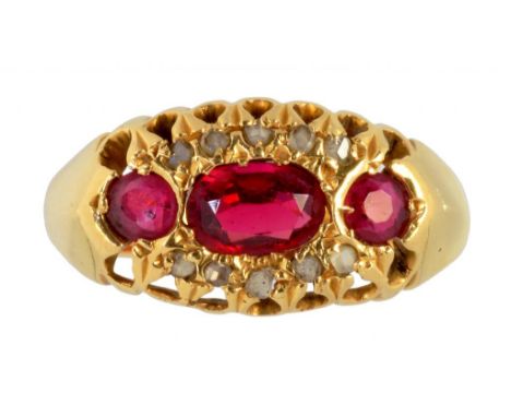 A RUBY AND DIAMOND RING with three larger oval or round rubies in 18ct gold, Birmingham, marks rubbed, probably 1913, 2.8g, s