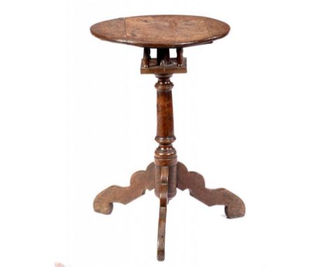 A GEORGE II OAK TRIPOD TABLE, C1750-70  the tilting top with iron latch and 'birdcage' action, on turned pillar and unusual p