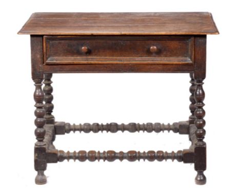 A WILLIAM III OAK SIDE TABLE, C1690 the rectangular three plank top with ovolo lip to all sides,  on bobbin turned legs and b