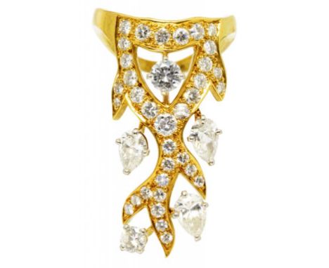 A DIAMOND DRESS RING, MOUNTED BY CARTIER  with round brilliant and larger pear shaped diamonds, in gold, signed Mtd. Cartier,