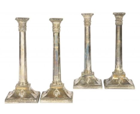 A SET OF FOUR SHEFFIELD PLATE NEO CLASSICAL STYLE CANDLESTICKS, C1775  with gadrooned rims, the flared square foot embossed w