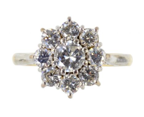 A DIAMOND CLUSTER RING  of nine round brilliant cut diamonds, the largest of 0.25ct approx, in gold marked 18ct, 4.3g, size K