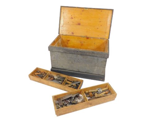 A carpenter's tool chest, containing a collection of woodworking tools, planes, chisels, etc. 