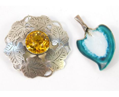 A C T S Nielsen circular silver brooch, cast and engraved as a circle of leaves, surrounding a citrine coloured faceted glass