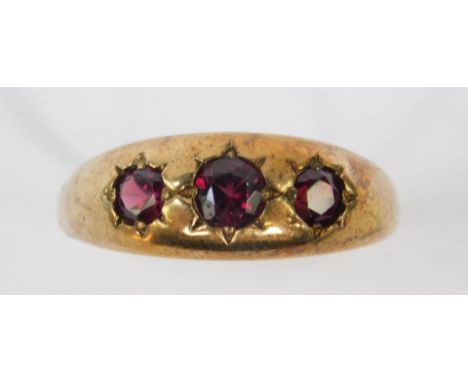 A 9ct gold gentleman's gypsy ring, set with three garnets, size 2, 4.7g. 