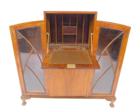 An Art Deco walnut break top secretaire bookcase, the central fall flap opening to reveal a drawer and recesses, over a singl