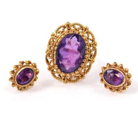 A 9ct gold and oval cut amethyst set ring, in a filigree setting, size L/M, together with a pair of matched earrings, 7.7g. 