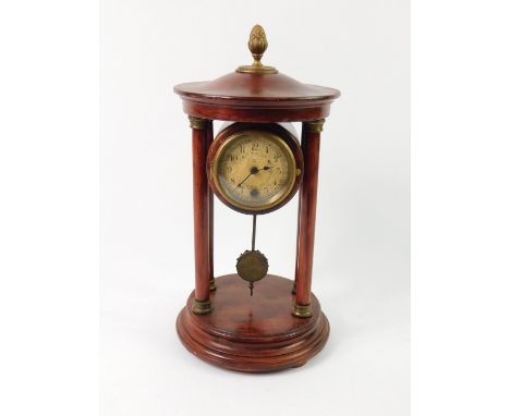 An HAC stained pine late 19thC portico clock, circular dial bearing Arabic numerals, the case with acorn finial raised on fou