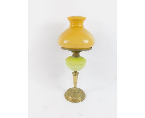 A duplex Art Nouveau brass oil lamp, with a green opaline glass reservoir moulded with flowers and spiral fluting, with an or
