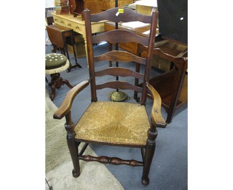 A Georgian Lancashire ladder back armchair with rush seat