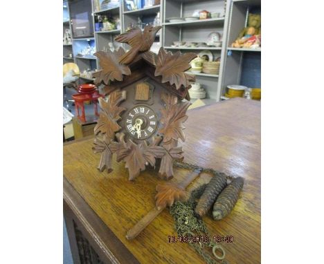 A small cuckoo clock with weights 
