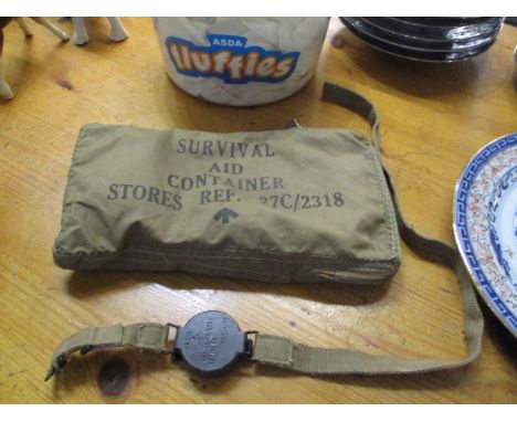 A military compass, together with an incomplete 'Survival Aid Container Stores' pouch 