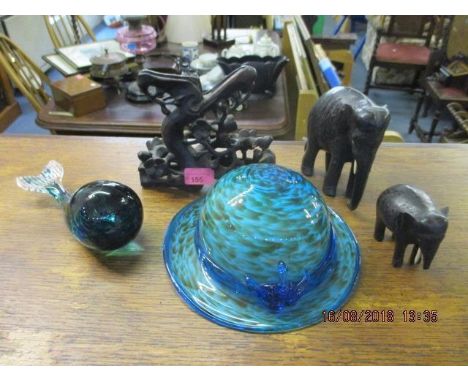 A mixed lot to include a Wedgwood Whale paperweight, a glass hat, two ebony carved elephants and another carving 