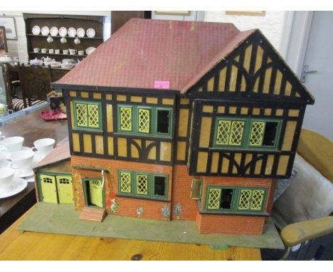 A vintage painted dolls house with accessories 