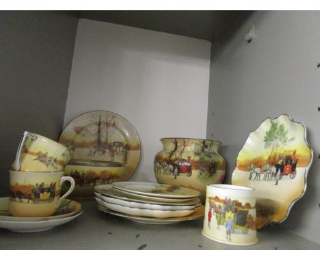 A collection of Royal Doulton Old Coaching Days ceramics to include a salad bowl, plates, cups and saucers and a vase 