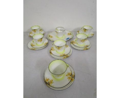 A Royal Albert Laburnum pattern part tea set comprising one bread plate, one milk jug and six cups, saucers and side plates 