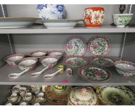 An early 20th century famille verte rice set, comprising five plates, six rice bowls and four spoons, along with an enamelled