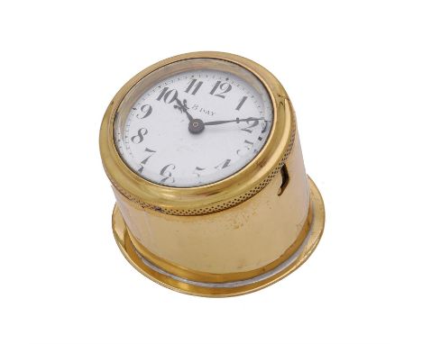 A brass vintage automobile dashboard timepiece.