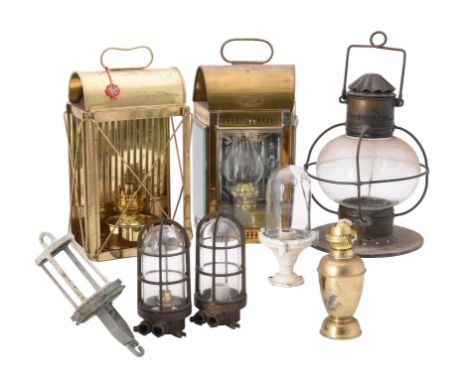 A brass hanging ships lamp,with wire guard and swing handle, pair of brass cased lamps with carrying handles, brass oil lamp 