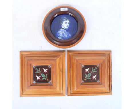 A pair of pine-framed Victorian tiles with fuchsia design, and a tile portrait of a young girl in a circular frame, 23.5cm ov