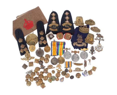 A large collection of various military badges, buttons, epaulettes, etc 