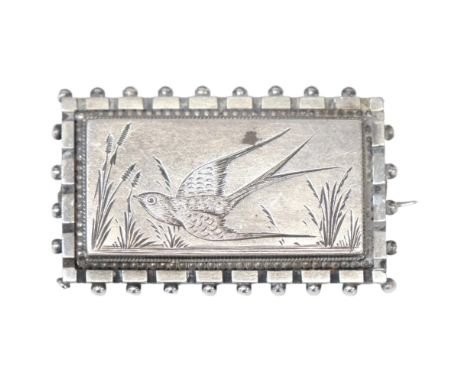 A Victorian Aesthetic Movement memorial brooch, engraved swallow bird decoration, unmarked silver settings 