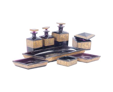 A collection of early 20th century amethyst glass dressing table bottles and dishes, including 3 scent bottles and stoppers, 
