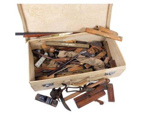 A collection of Vintage woodworking tools, including planes, moulding plane, folding rules, etc, in a pigskin suitcase 