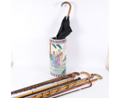 A modern Oriental decorated ceramic stick stand, overall height 48cm, and a selection of hardwood walking sticks, canes, and 