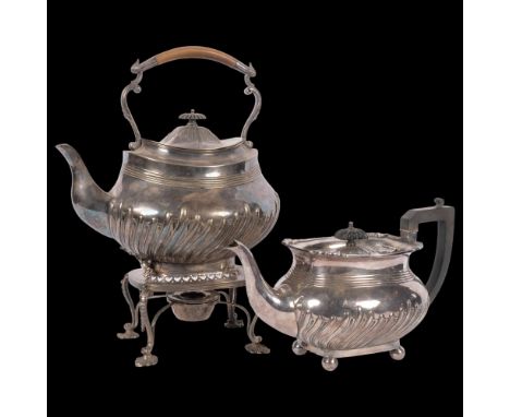 A large silver plated spirit kettle on stand, complete with burner of half fluted form, and matching teapot, with armorial cr