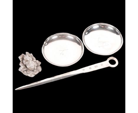 An Elizabeth II silver meat skewer/page turner, a small silver dish, and a sterling silver-clad paper weight in the form of a