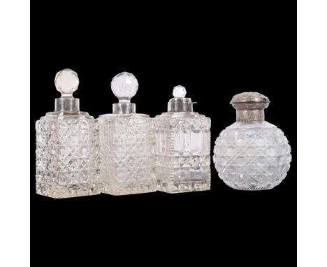 A pair of cut-glass scent bottles with silver collars, another (lacking lid), and a cut-glass scent bottle with embossed silv