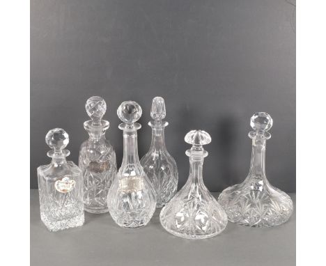A group of 6 cut-crystal decanters and stoppers, including a ship's decanter, H16cm, a ceramic Whisky label, and 2 silver pla