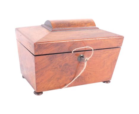 A Victorian walnut sarcophagus tea caddy, with inner lids and silver plated spoon, 22cm across 