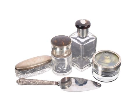 A collection of various silver-topped jars, scent bottle, cake slice, etc 
