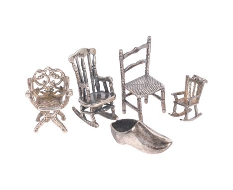 5 pieces of silver doll's house furniture, including a rocking chair, a ladder-back chair, and a Savonarola chair, a miniatur