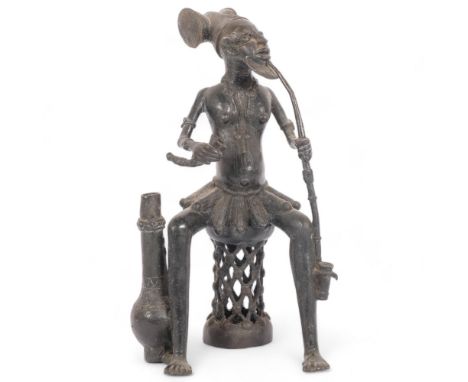 A cast-bronze figure, Yiruba, Nigeria?, study of a seated man smoking a pipe, H29cm 