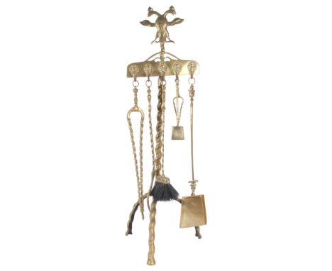 A polished brass floor-standing companion set, with 6 various tools, stand surmounted by double-headed bird, H100cm 