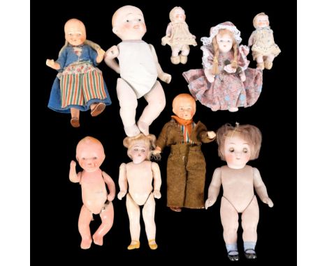A collection of Vintage miniature porcelain and other dolls with jointed limbs 