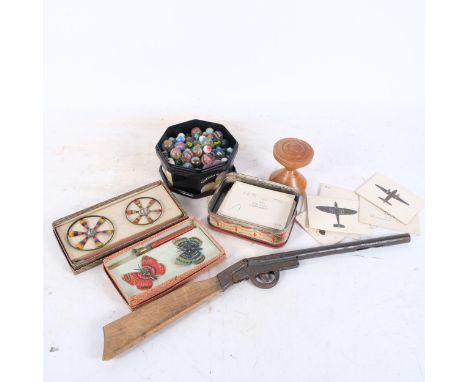 Vintage toys, including marbles, rifle, Marklin spinners and butterflies, etc 