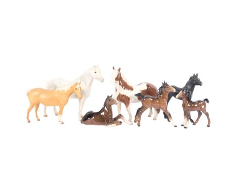 A quantity of Beswick and other ceramic horses, including various seated and standing examples, largest height 16.5cm (7) 