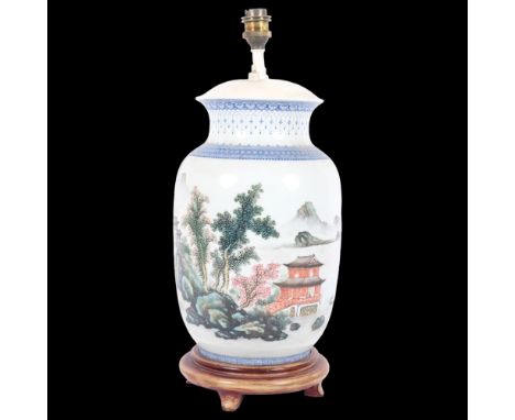 A Chinese blue and white table lamp on turned wood stand, painted with pagoda and mountain decoration, height to top of bayon