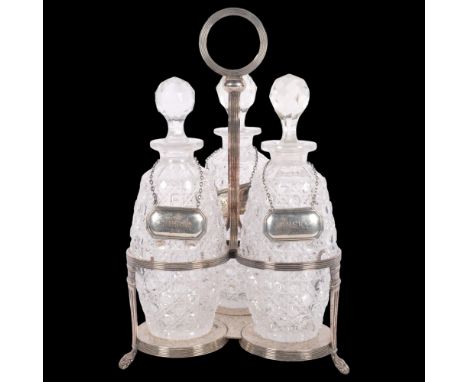 An early 20th century 3-bottle table decanter with plated stand, with 3 silver decanter labelsDecanters all in good condition