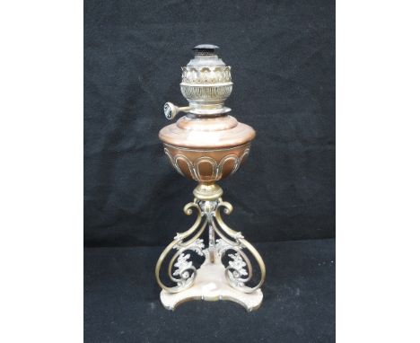 A VICTORIAN OIL LAMP, with a brass base and copper reservoir