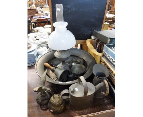A LARGE BRASS BOWL, an oil lamp and similar items of metalware