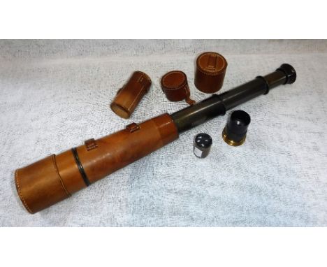 A THREE DRAW TELESCOPE reconditioned for 'John Barker & Co Ltd Kensington by Broadhurst Clarkson & Co' in a leather binding, 