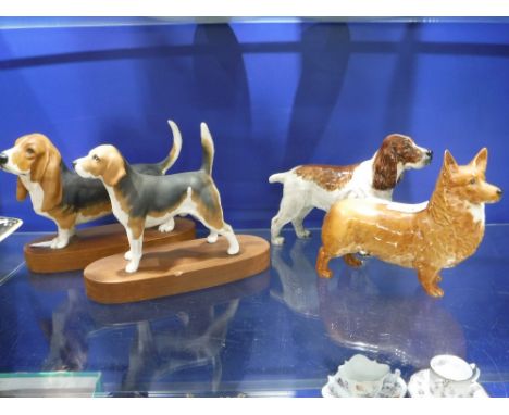 A BESWICK MODEL OF A CORGI and three similar dogs