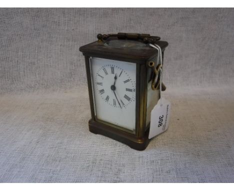 A BRASS CASED CARRIAGE CLOCK with white enamel dial